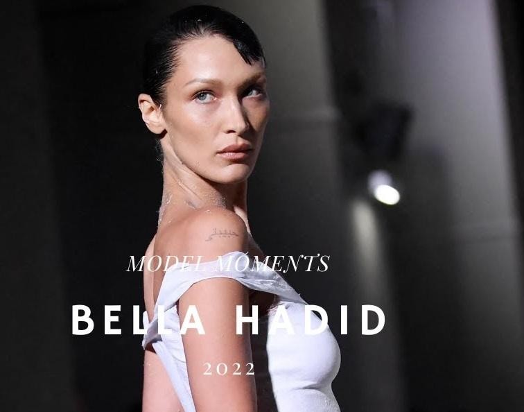 Bella Hadid podczas akcji charytatywnej, z wyrazem empatii i zaangażowania.